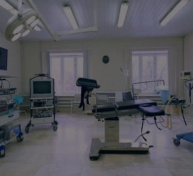 A hospital room with medical equipment and a television