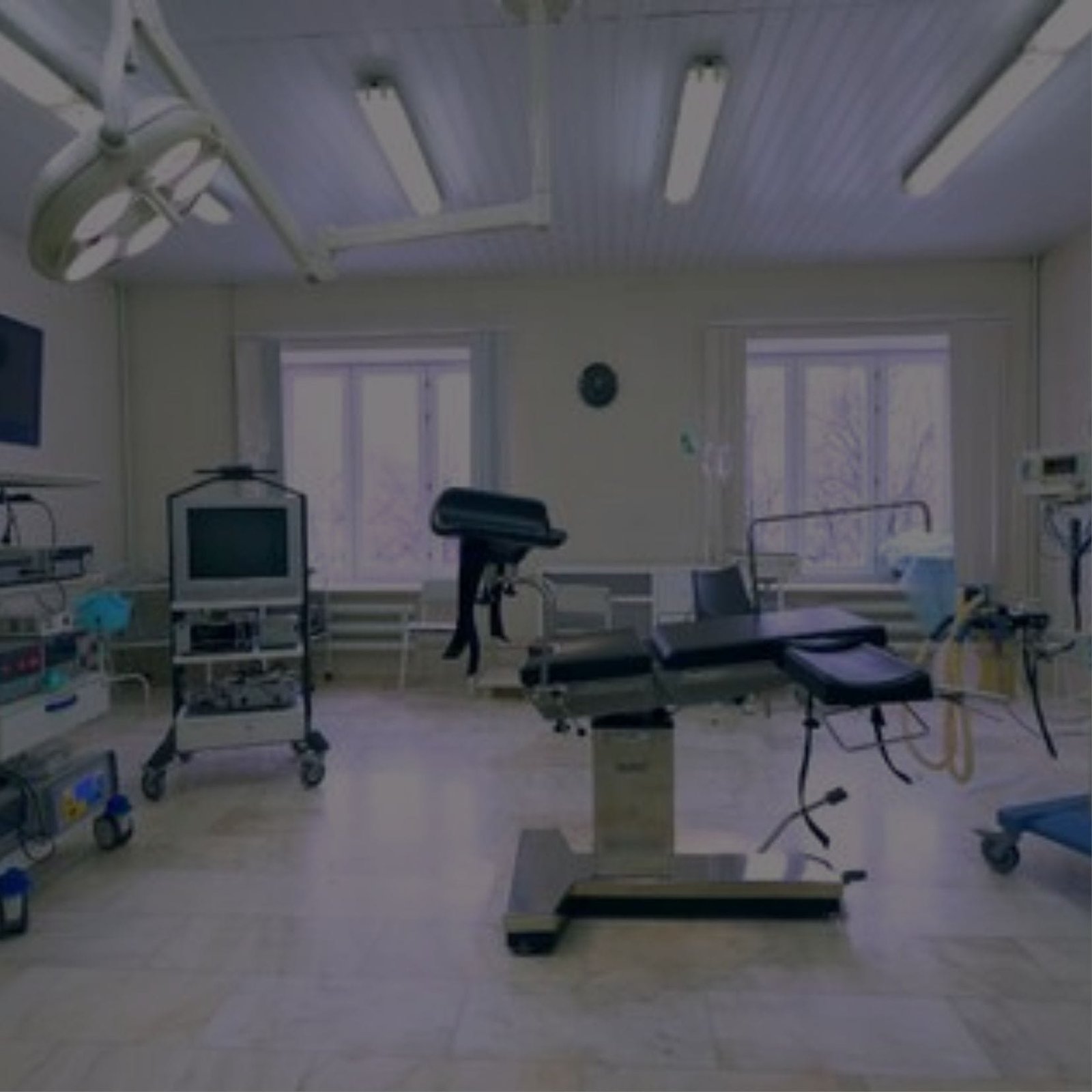 A hospital room with medical equipment and a television