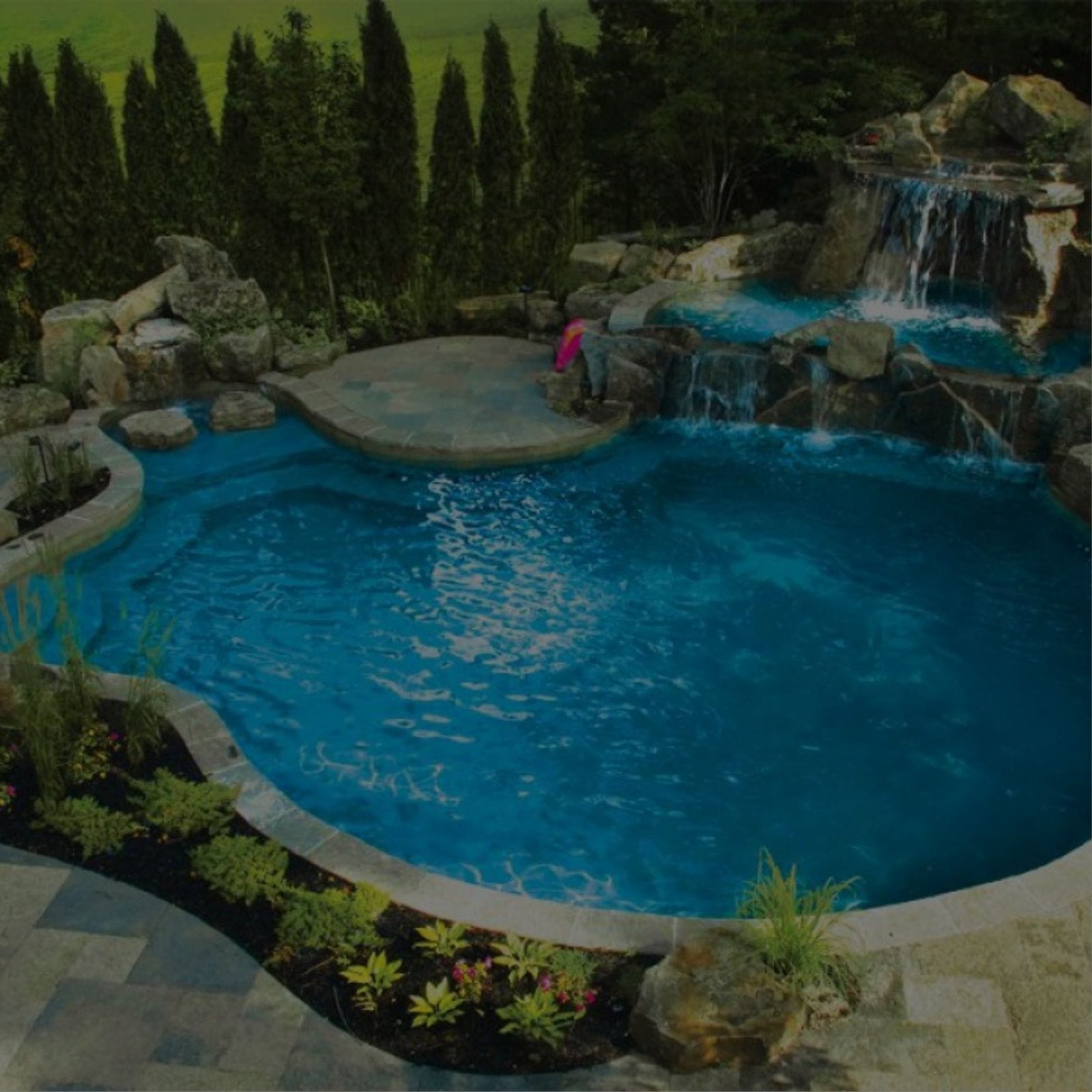 A sparkling blue swimming pool with people swimming and lounging by the water
