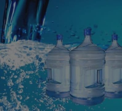 Three water bottles on a blue surface