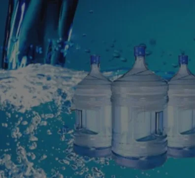 Three water bottles on a blue surface