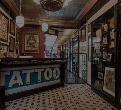 A tattoo shop with a sign that says tattoo