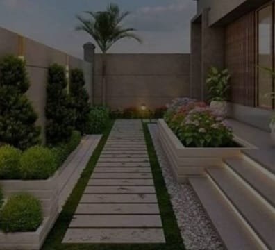 A landscaper working on a garden, trimming plants and arranging flowers