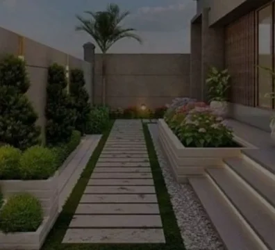 A landscaper working on a garden, trimming plants and arranging flowers