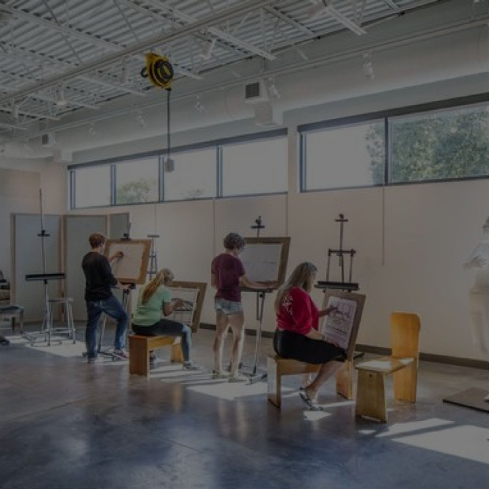 A diverse group of artists creating artwork in a vibrant art studio