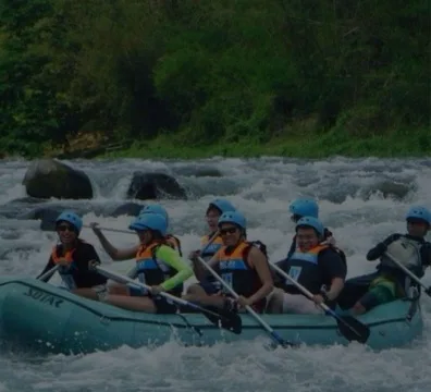 A group of people on a raft, floating down a river