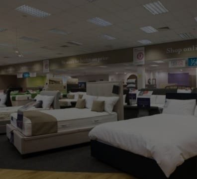 A spacious room with multiple beds and mattresses