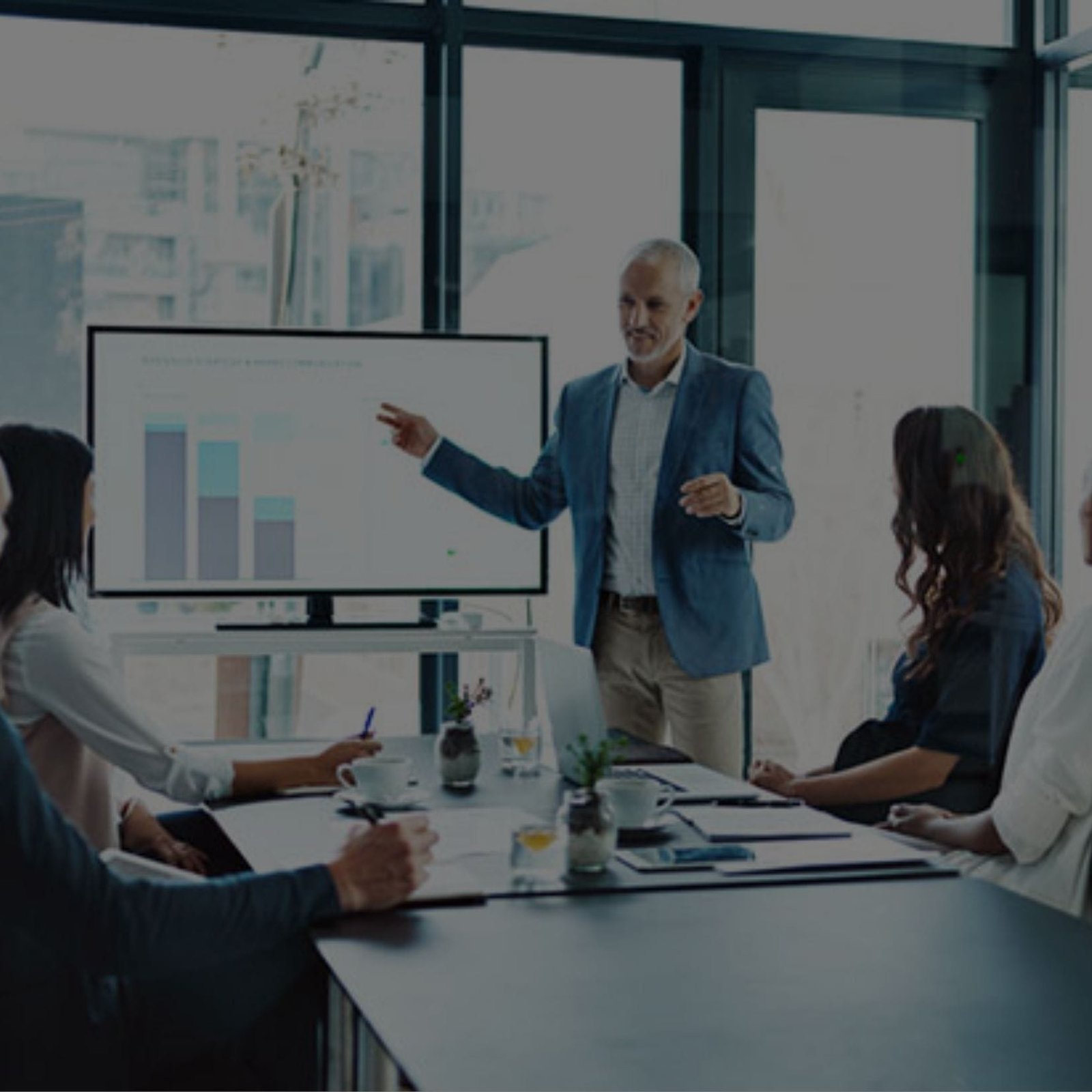 A presenter discussing business matters with a group of attentive listeners