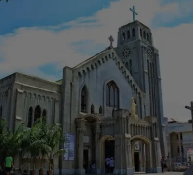 A church with a tall tower and a cross on top