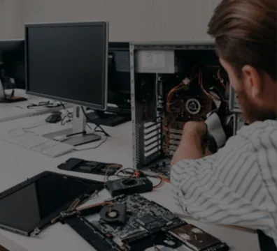 A man sitting at a desk, working on a computer