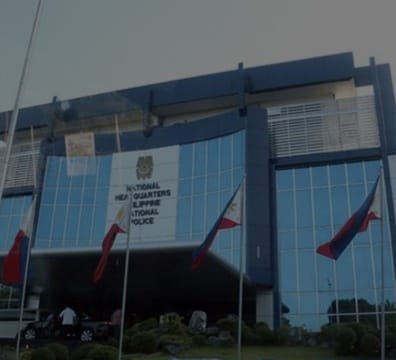 A grand building with flags waving in front