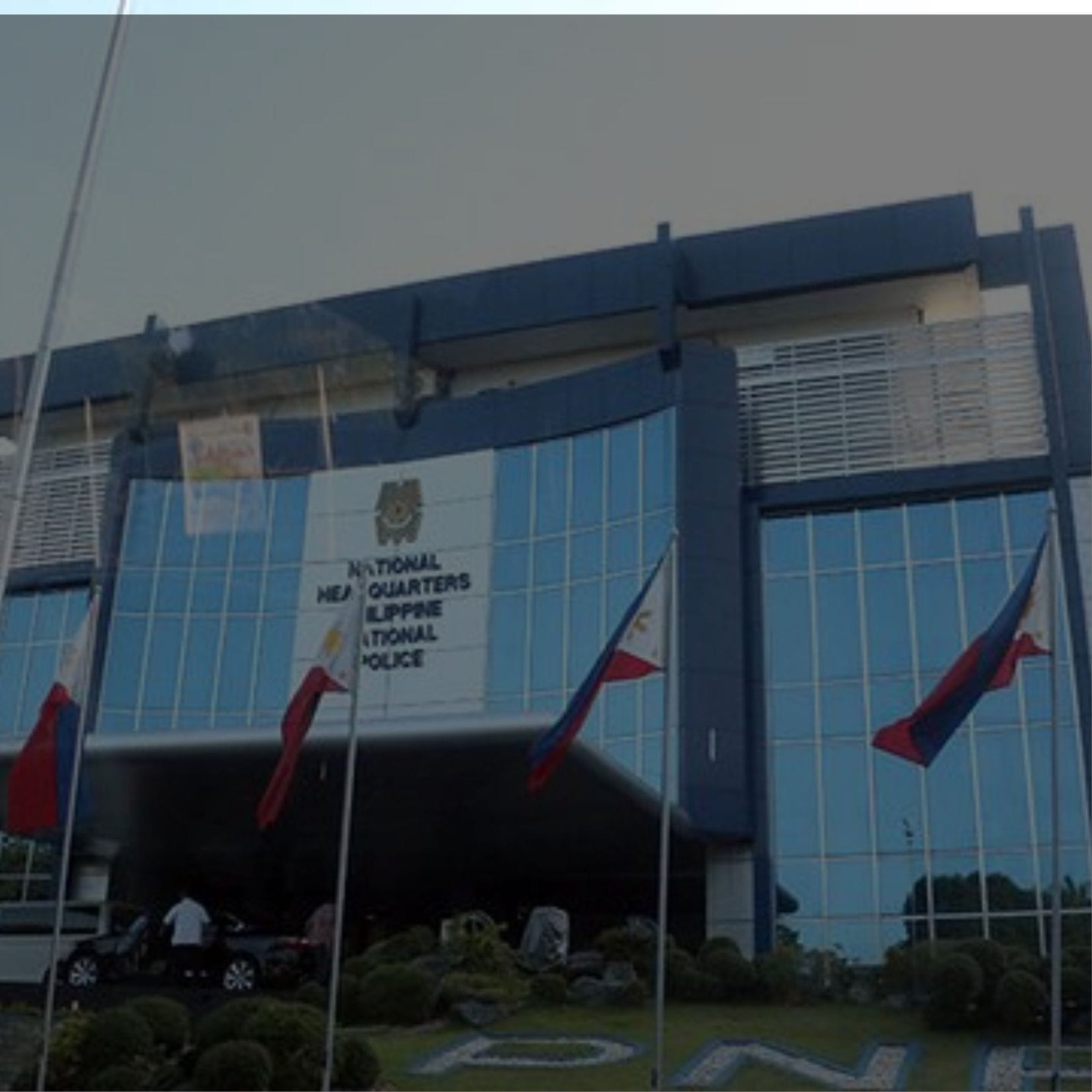 A grand building with flags waving in front