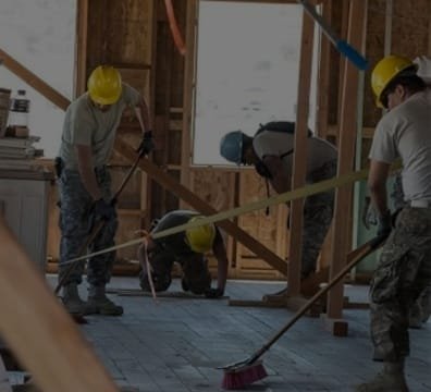 workers cleaning up a house after construction
