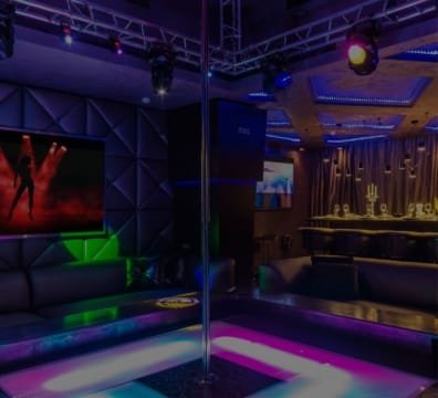 A nightclub with a pole and a TV