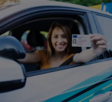 A lady holding up her driver's license for identification
