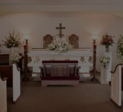 A funeral church with a white altar and pews