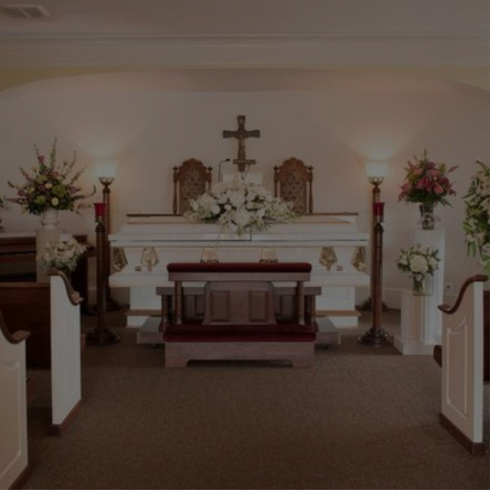 A funeral church with a white altar and pews
