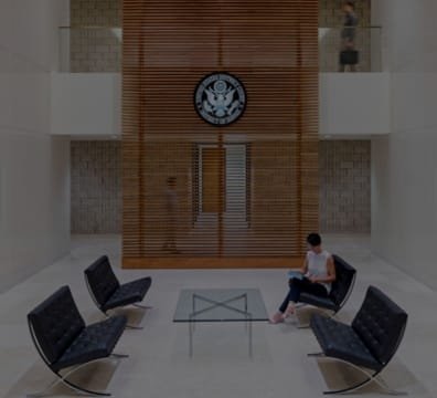 A woman sitting in a chair at a government office