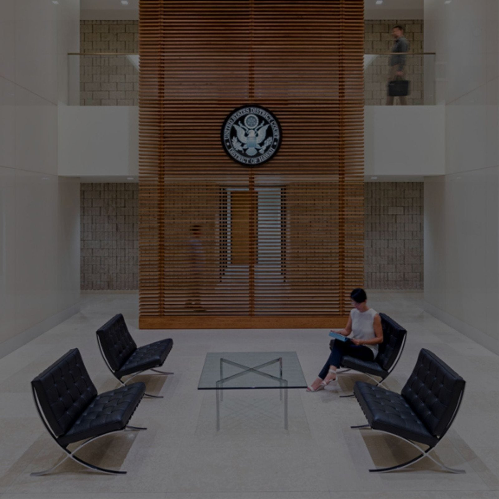 A woman sitting in a chair at a government office