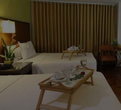 A hotel room with two beds and a tray of food. Perfect for a comfortable stay at hotels & inns