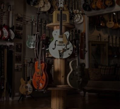 A variety of guitars on display in an instrument store.