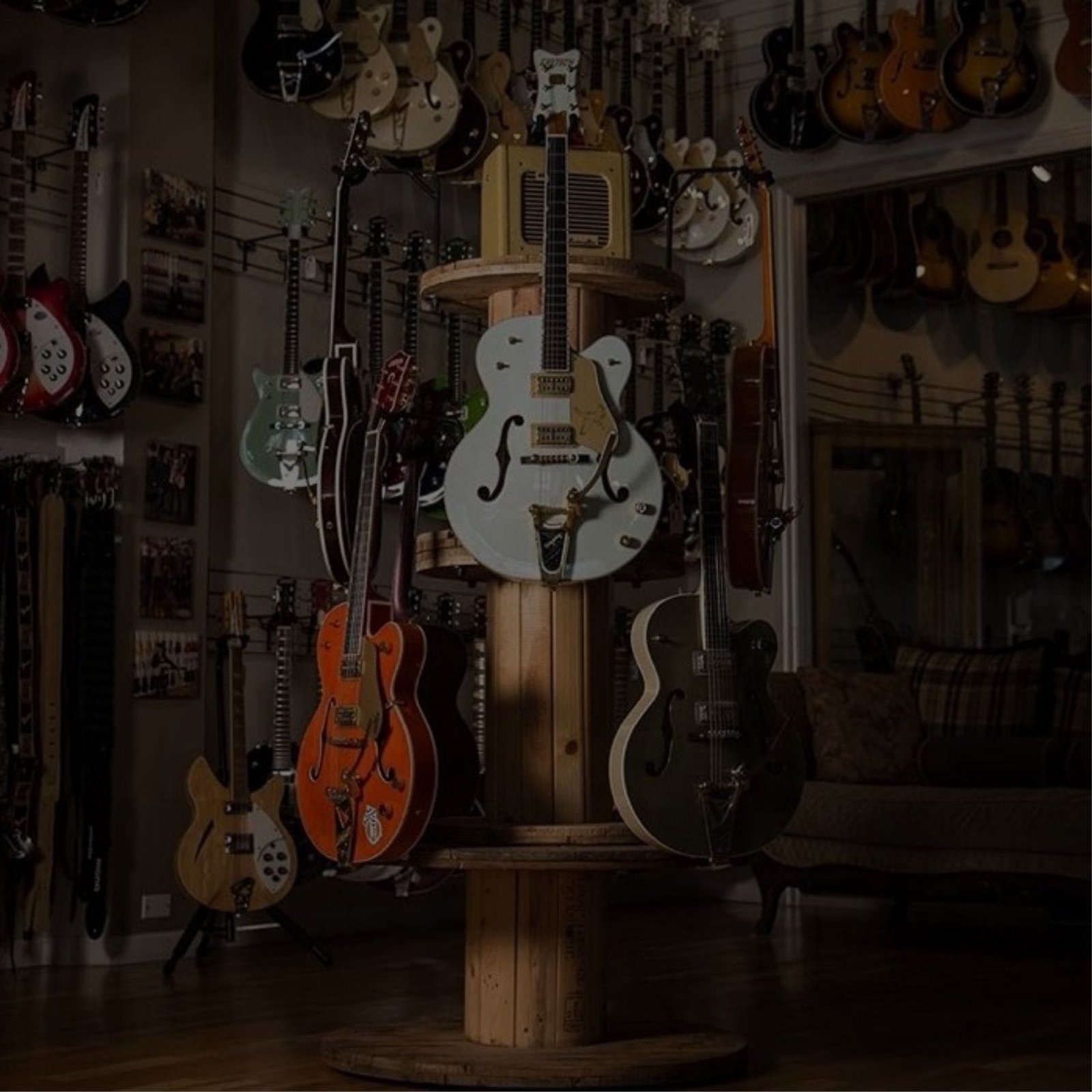 A variety of guitars on display in an instrument store.