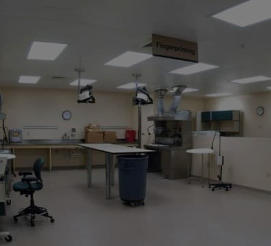 A mortuary service space featuring a desk and chairs in a large room