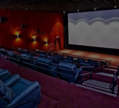 A movie studio with cameras, lights, and actors on a film set