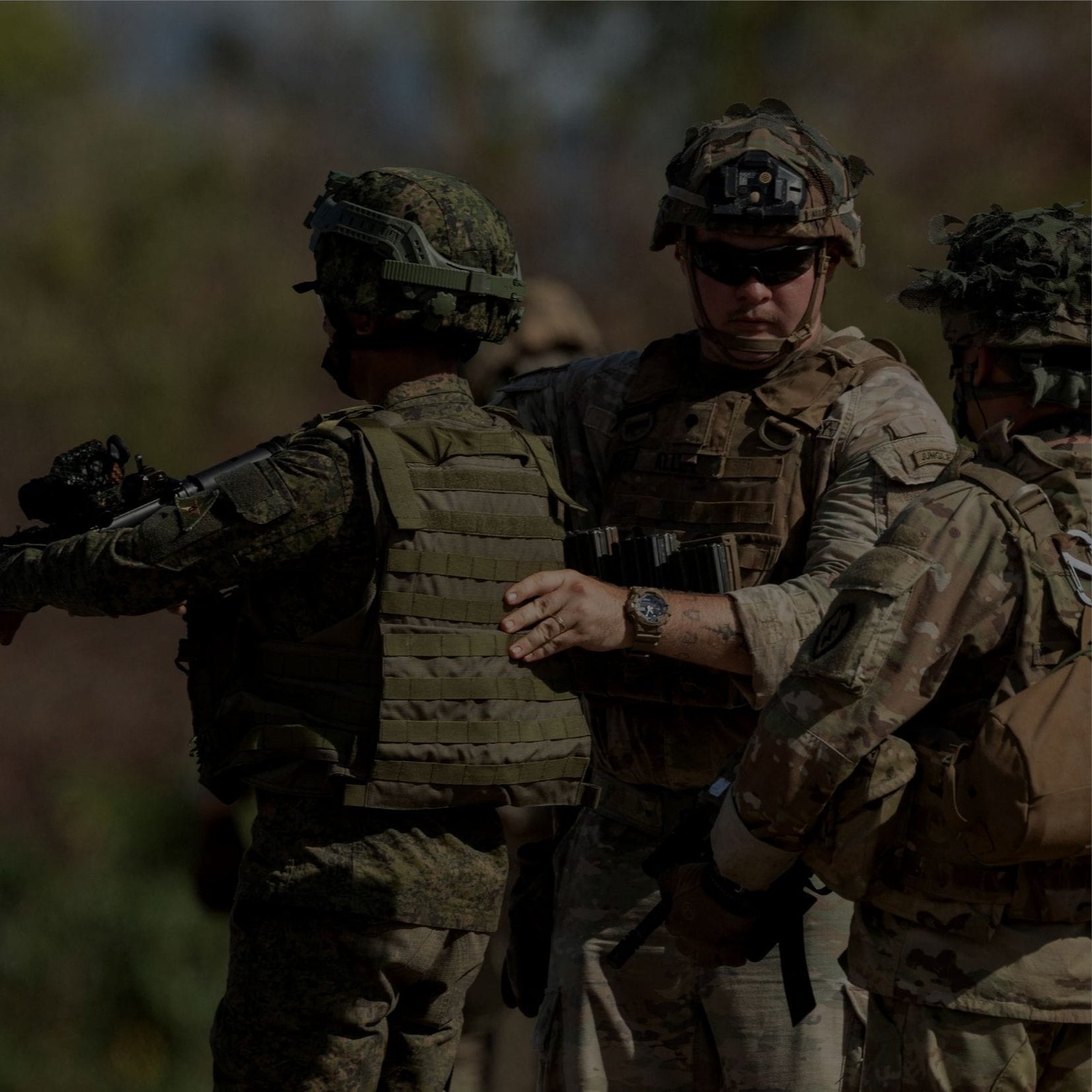 A group Military Base and Coast Guard standing together in a field, ready for action.