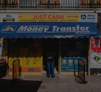 A person holding cash and a smartphone, Money Transfer Service to another person using a mobile app