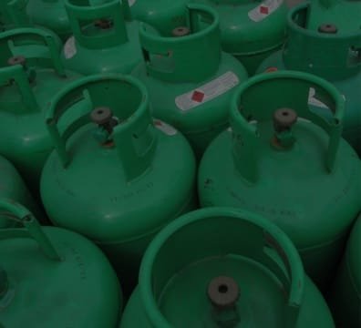 Many green Fuel Gas Supplier and cylinders stacked together
