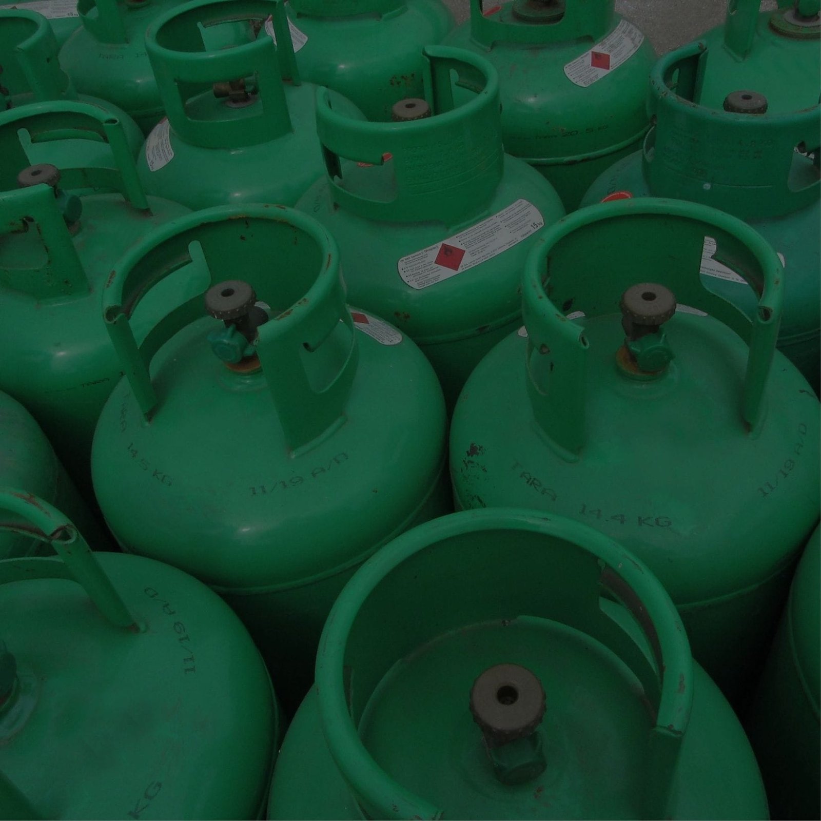 Many green Fuel Gas Supplier and cylinders stacked together