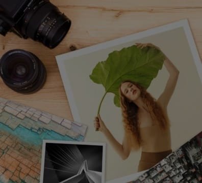 A woman holding a leaf and a camera on a table. Digital Printing services