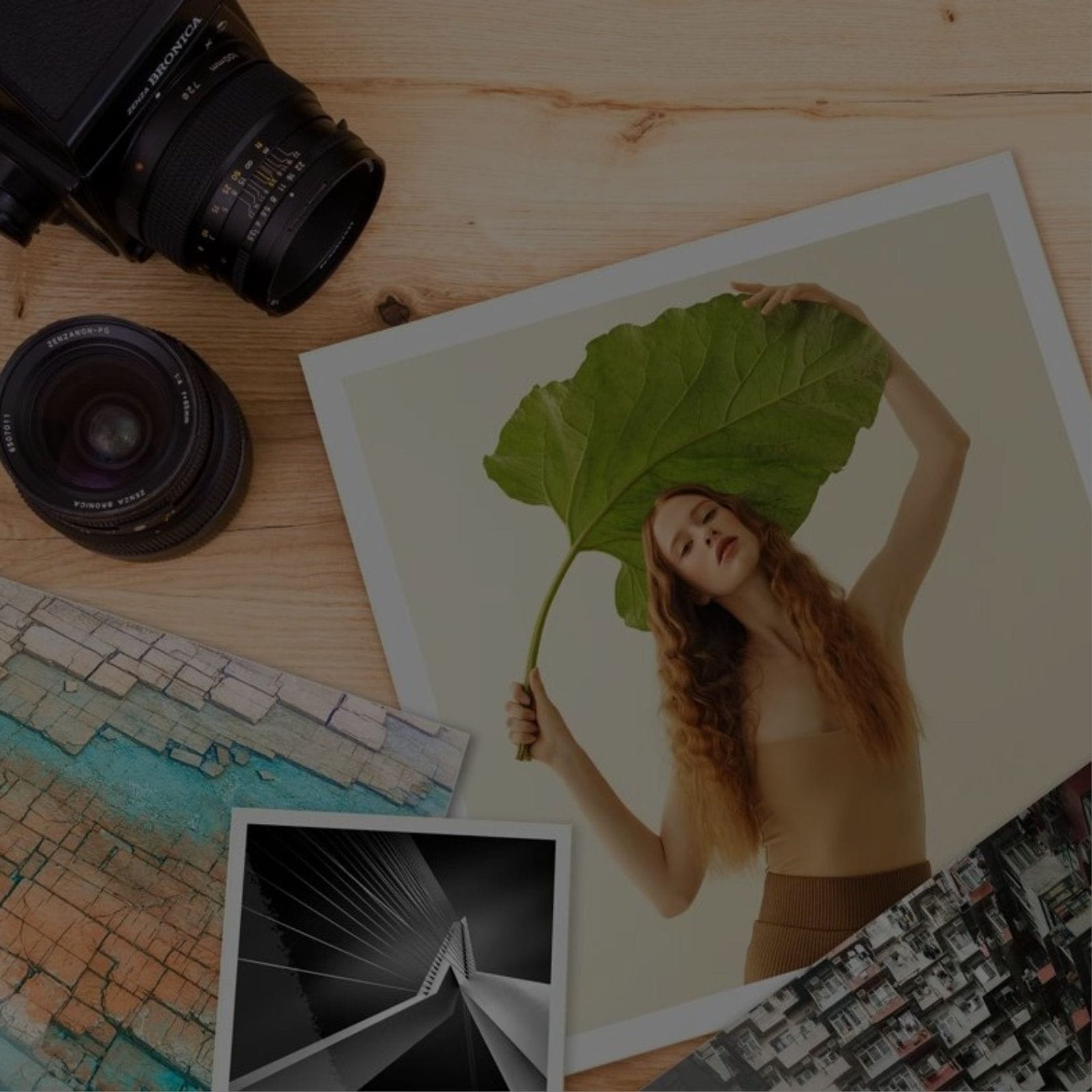 A woman holding a leaf and a camera on a table. Digital Printing services