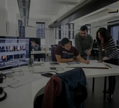 A team of professionals collaborating on a project in an office at an agency
