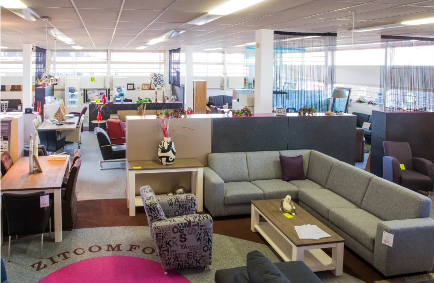 A spacious room featuring various pieces of furniture arranged for comfort and functionality.